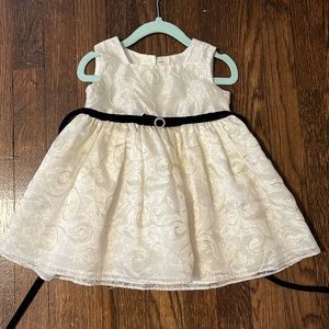Beautiful cream colored dress with black wrap around velvet ribbon